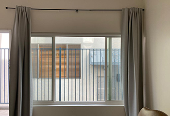 Sheer roller shades combined with curtains in a small living room in Santa Clara